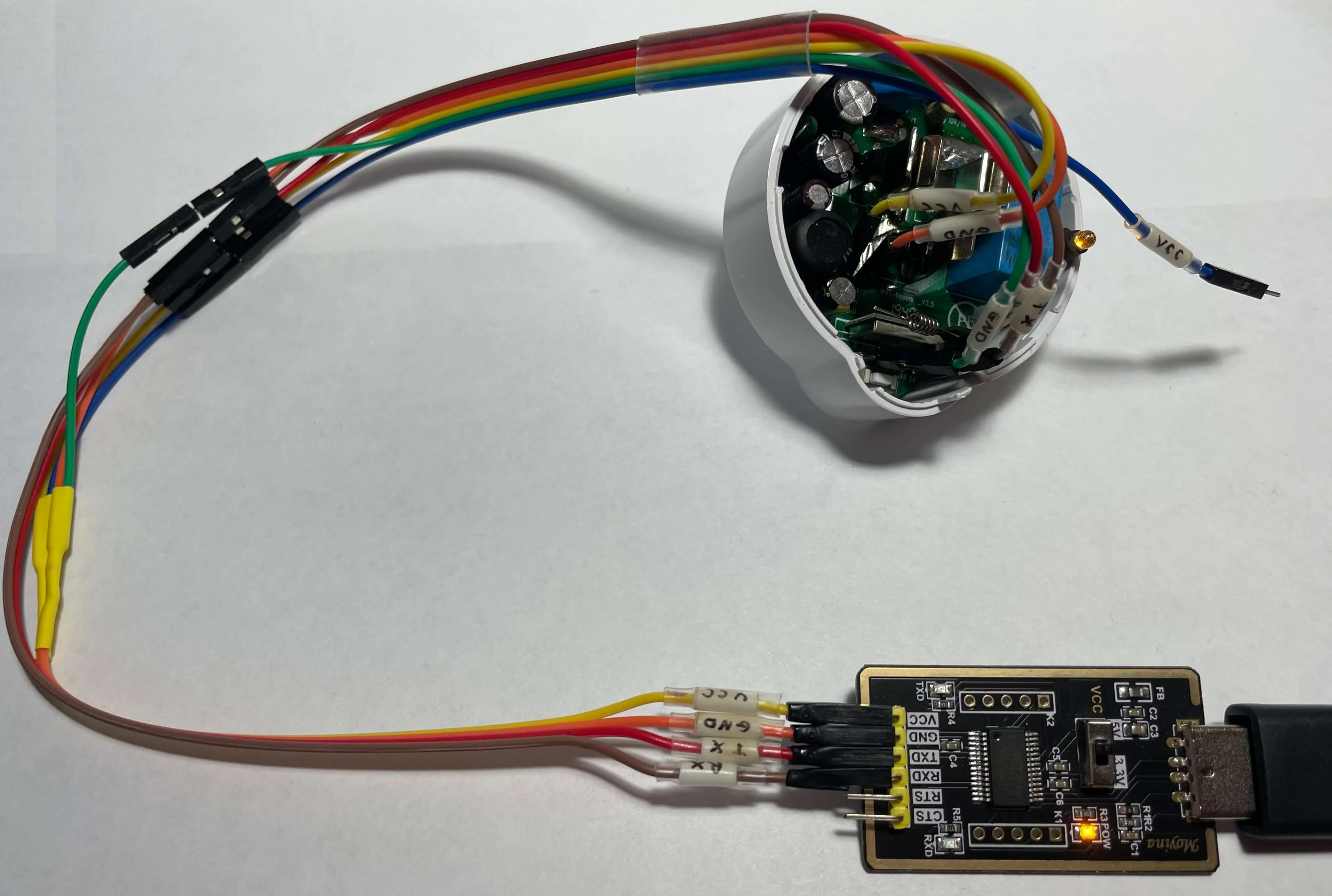 Etekcity Voltson ESW01-USA-R6P Connected to a USB serial converter and Booted into Flash Mode An angled view of the Etekcity Voltson ESW01-USA-R6P connected to a USB serial converter as described in the table above and booted into Flash Mode.